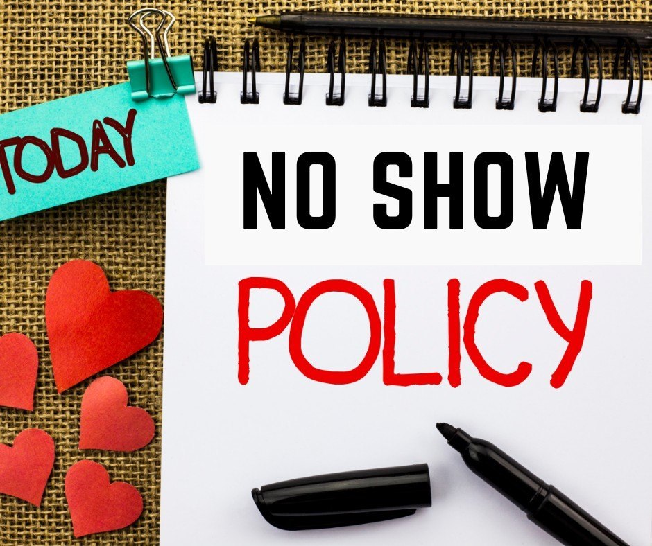 A spiral notebook displaying the words No Show Policy beside a marker.
